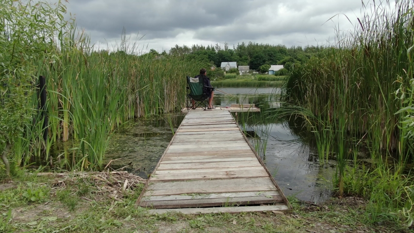 Man fishing on a platform in the lake