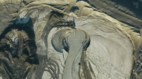 Climate change.Pollution.High aerial zoom out view of environmentally dangerous toxic water pouring into tailing dams at a mine