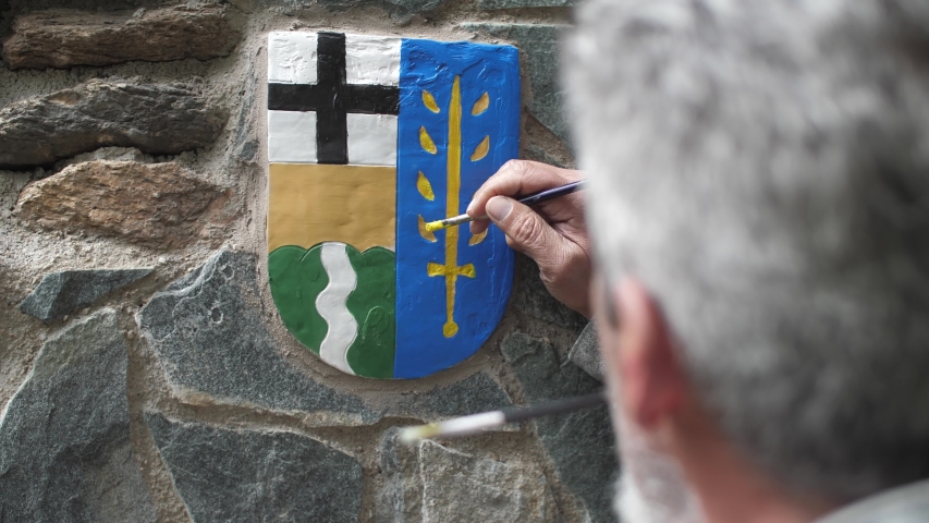 Coat of arms painted by older man, emblem of a small Czech village in Ore Mountains region