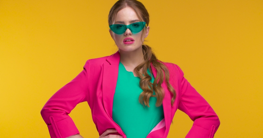 Stylish Fashionable Woman posing on yellow Background, looking Confident Fashionable colorful Outfit.