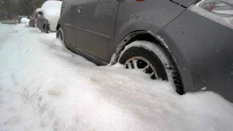 close up of car wheels stuck in snow drift car covered with snow