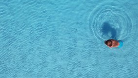  AERIAL.A young beautiful woman swims under the water.