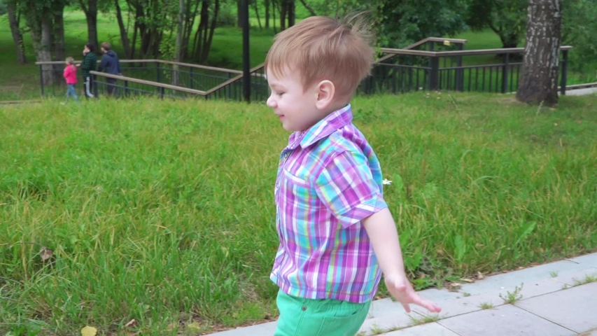 The boy runs to his mother and hugs her