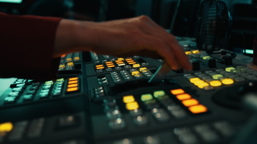 Broadcast Tv Studio Production - Vision Switcher Studio Director broadcast video mixer operation - Close-up of hand. Hands of a cinematographer who worked on the vision mixer, switch the TV panel. | Shutterstock HD Video #1056938858