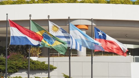 masts with flags of South American countries that are members of Mercosur waving in the wind, Paraguay, Brazil, Uruguay, Argentina, Chile