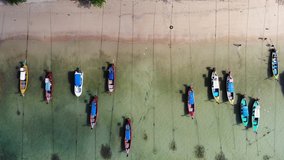Commercial fishing trawler boats in port in Thailand. Aerial view of speed boat parking on beach. Cage fish farming. Aerial video with drone over the sea with boats. Artisan fishermen close of beach.
