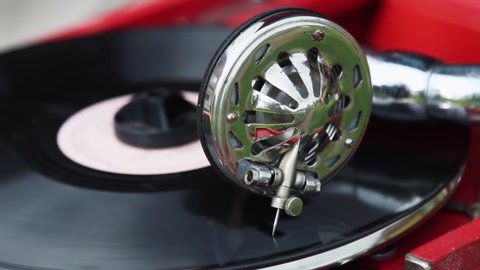 playing an old retro gramophone with a vinyl record