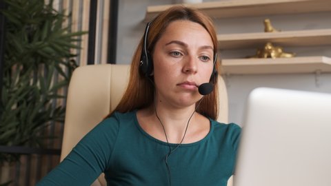 Service phone operators. Agent woman in headset use pc answers incoming calls talk with client provide at home