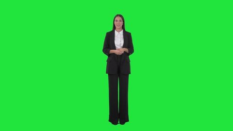 Elegant business woman in suit talking and advertising during presentation. Full length on green screen background