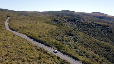 4K Aerial drone panoramic footage of small family car moving through wilderness. Transportation, car rental, insurance concept.