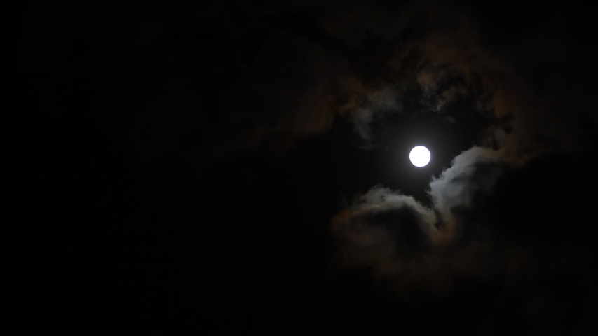 Clouds passing by moon at night. Full moon at night with cloud real time. mystery fairyland scene. Royalty-Free Stock Footage #1056962843