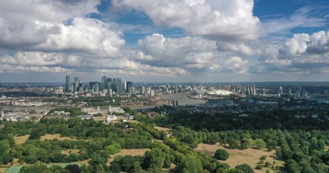 Greenwich, London / United Kingdom - AUGUST 04, 2020: Aerial view of the London skyline with a view of Canary Wharf and the O2 arena.
