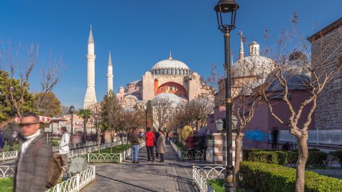 Hagia Sophia timelapse hyperlapse with trees in park, Christian patriarchal basilica, imperial mosque and now a museum, Istanbul, Turkey