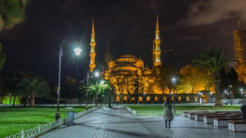 Blue Mosque timelapse hyperlapse at night with golden illumination, Istanbul in dusk. Sultanahmet Camii mosque with six minarets - famous islamic monument of the Ottoman architecture in Turkey.