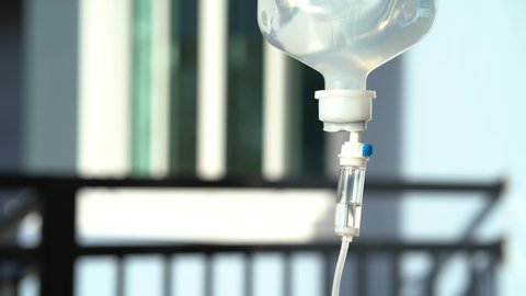 Closeup of IV drip in hospital, Intravenous saline solution, IV loading. 