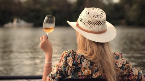 Pretty Lady Relaxing After Hard Working Day And Celebrating Holidays Vacation. Romantic Evening Enjoying With Wineglass. Happy Woman Hold Glasses And Drinking Wine. Woman Drinking White Wine Outdoor