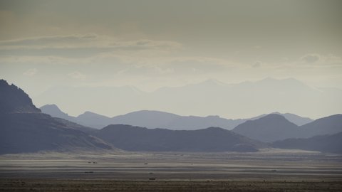 Panning shot of scenic distant mountain range / Dugway, Utah, United States