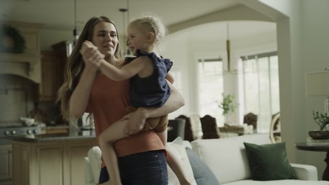 Slow motion of mother carrying and dancing with daughter / Cedar Hills, Utah, United States