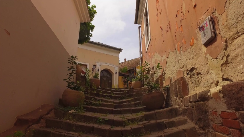Urban alley with old buildings and stairs, narrow street. Szentendre, Hungary Europe. 4K