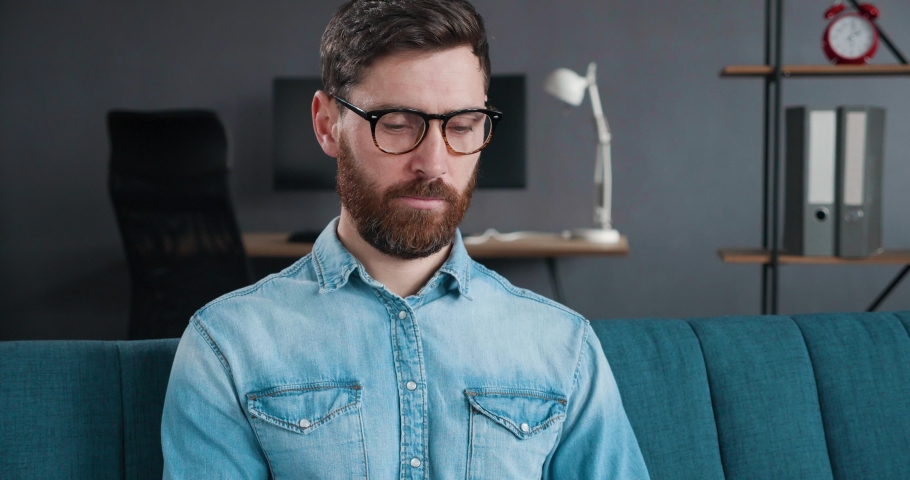 Confident happy Businessman wearing Glasses, looking at the Camera in Home Office. Positive male Employee Executive smiling Face satisfied with good job Career. Successful Freelancers Portrait.