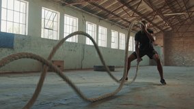 Fitness man exercising with battle rope abandoned warehouse. Tough man working out in cross training gym made inside old factory.
 - Powered by Shutterstock - Get 15% off with code: PIKWIZARD15