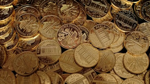 Large pile of bullion gold coins falling.