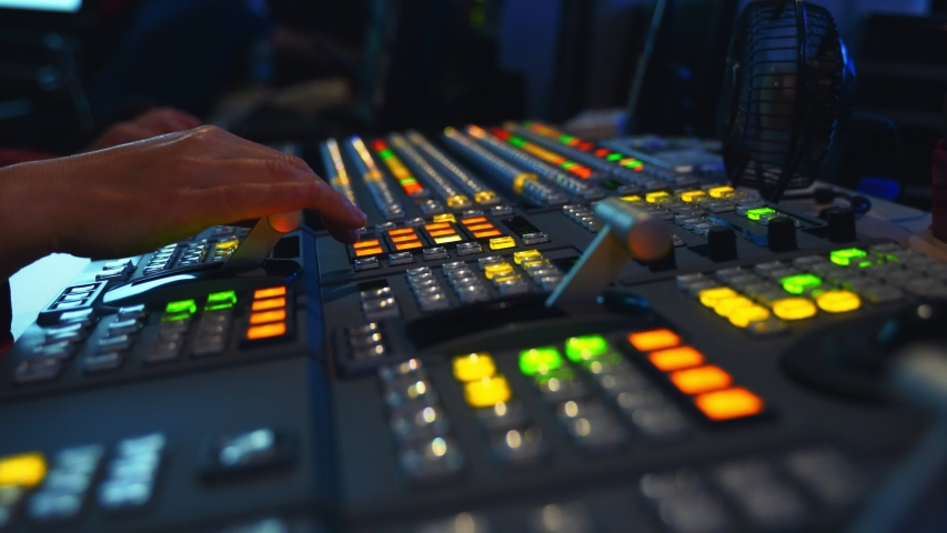 Broadcast Tv Studio Production - Vision Switcher Studio Director broadcast video mixer operation - Close-up of hand. Hands of a cinematographer who worked on the vision mixer, switch the TV panel. | Shutterstock HD Video #1057003151