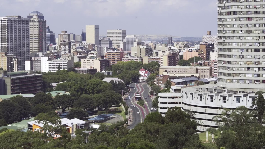 Street across the base of Ponte City Apartment in Johannesburg South Africa. Fixed shot, Long shot.