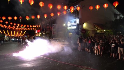 George Town, Penang / Malaysia - Jan 24 2020: Fire crackers is light up at street decorated with red lantern during chinese new year.