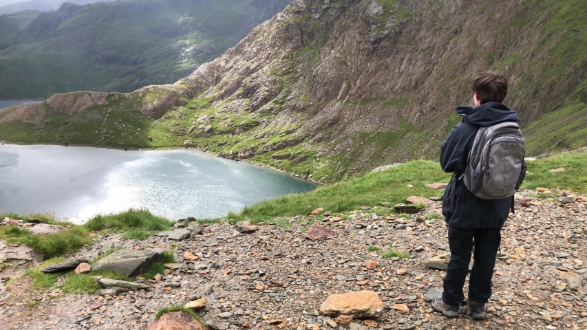 A teenager walks down Snowdon in Wales