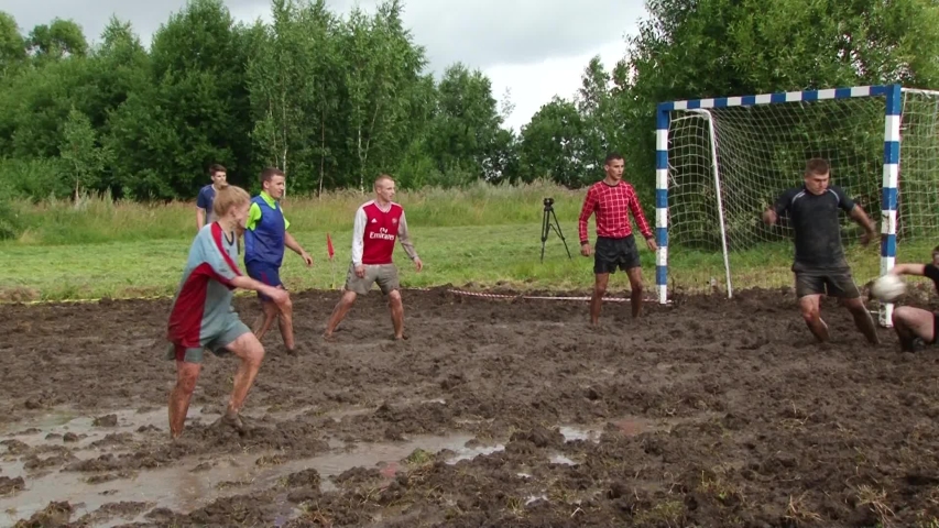 Swamp soccer championship in Belarus.Men playing soccer in the mud. Belarus/Oshmyany/1 August 2020 | Shutterstock HD Video #1057015460