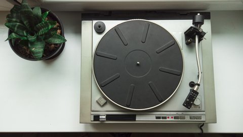 Stop motion of vintage vinyl record spinning on old vinyl record player. Listening retro music. 