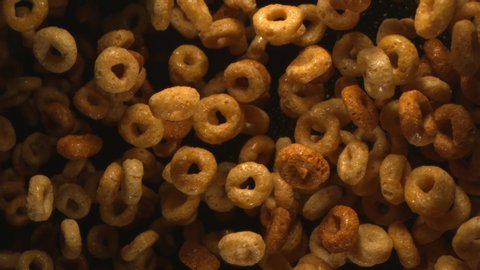 Round Breakfast Cereals Flying in the Air in Slow Motion on Black Background 4k