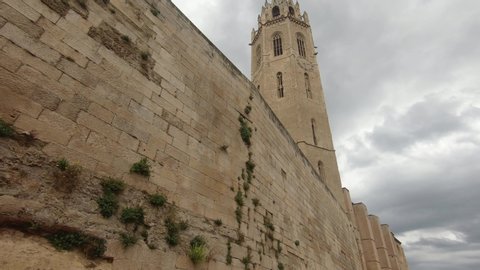 Walking near fortification wall towards Lleida Catalonia spain church tower