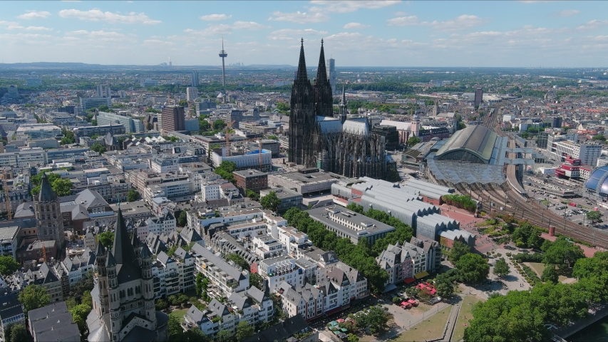 Aerial view of cityscape of Cologne, Cathedral Church of Saint Peter (Hohe Domkirche Sankt Petrus) in historic city center - landscape panorama of Germany from above, Europe | Shutterstock HD Video #1057036724