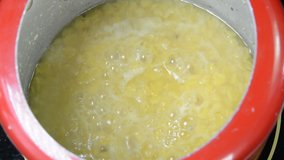 Cooking split pigeon peas in a pressure cooker. They are also called as Toor Daal in India.