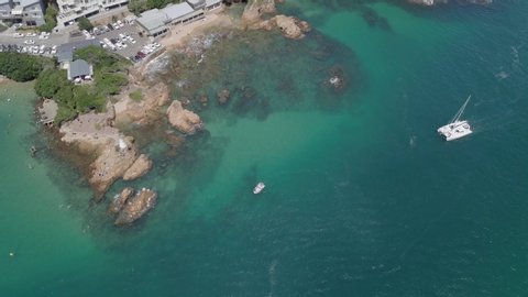 Catamaran approaches shore at Knysna East Head, South African aerial