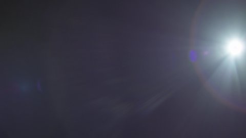 A blue lens flare on the right side with a fading effect in the end over a black background captured using a 35mm Precise lens from the Lucent Precise collection - Lens Flare Video Element.