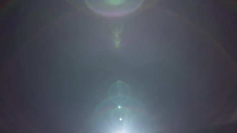 A blue lens flare appearing from the bottom right side moving to bottom left side captured using a 25mm Precise lens from the Lucent Precise collection - Lens Flare Video Element.