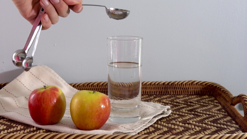 Adding apple cider vinegar to glass of water for weight loss and health Royalty-Free Stock Footage #1057051277