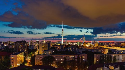 Day to Night Aerial View Time Lapse of Berlin cityscape with bright sun and clouds, Berlin, Germany