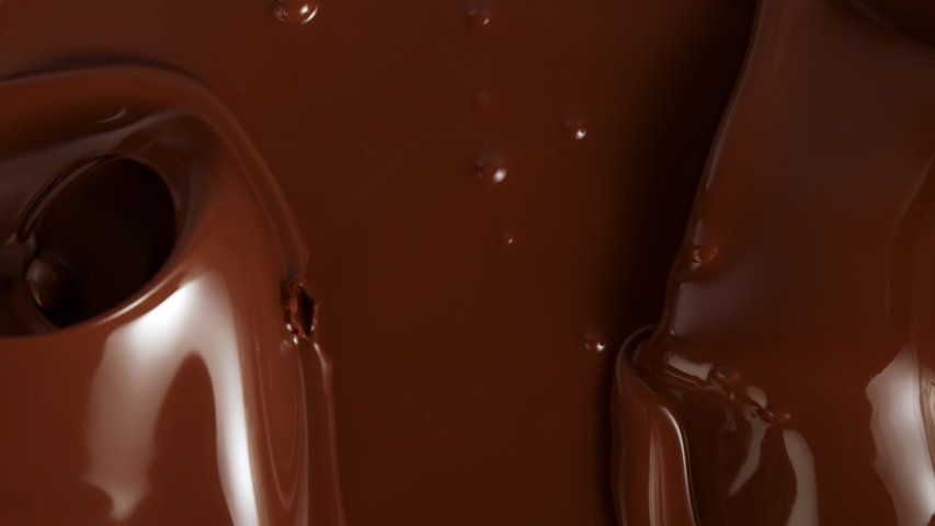Super Slow Motion Shot of Splashing Melted Chocolate Background at 1000fps. | Shutterstock HD Video #1057053374