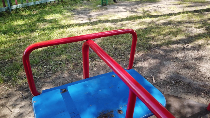 Empty playground, merry-go-round without children