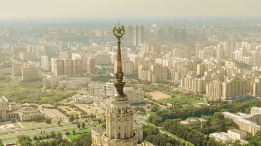 Aerial view of the cityscape as seen behing the spire and star of the historic Moscow State University building, Russia