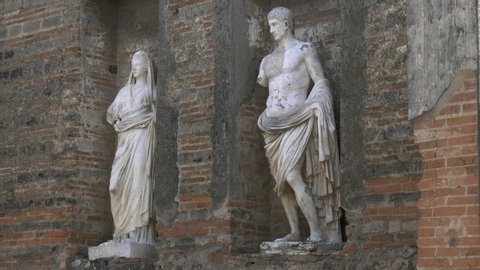 NAPLES, ITALY- JUNE, 13, 2019: zoom in on two marble statues at pompeii ruins