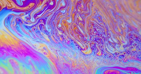 Surface of Liquid Soap with Changing Rainbow Colours. Macro.