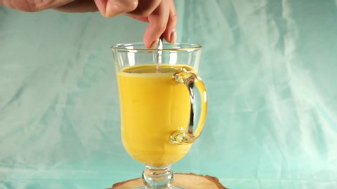 Golden milk in a glass cup