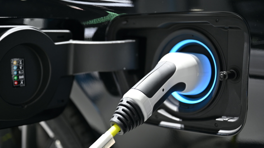 Electric vehicle charging port plugging in EV modern car. save ecology alternative energy sustainable of future | Shutterstock HD Video #1057101761