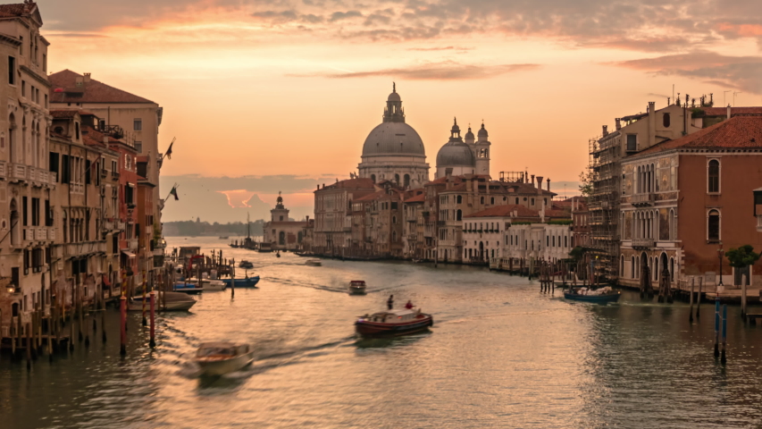 Time lapse Sun rising over of Grand Canal traffic and Basilica di Santa Maria della Salute, view from Accademia bridge, Venice, Italy Royalty-Free Stock Footage #1057108295