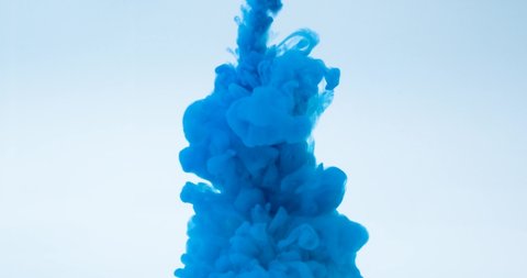Blue ink water explosion from above in slow motion. Acrylic ink in water on a white background. A powerful explosion of blue color. Blue paint leak.